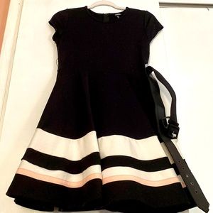 Black dress with pink and white stripes at the bottom